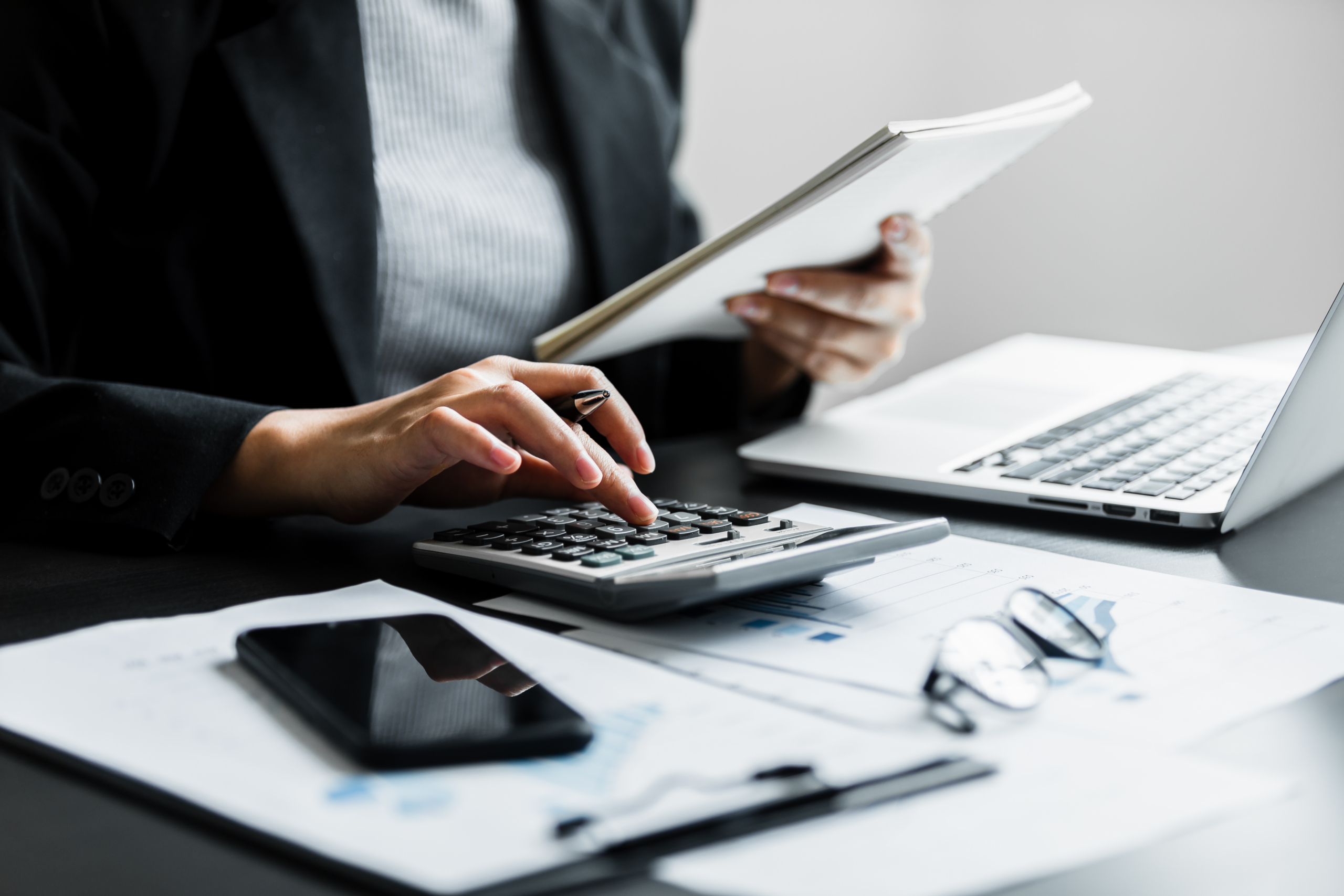 Tax documents and calculator on a desk
