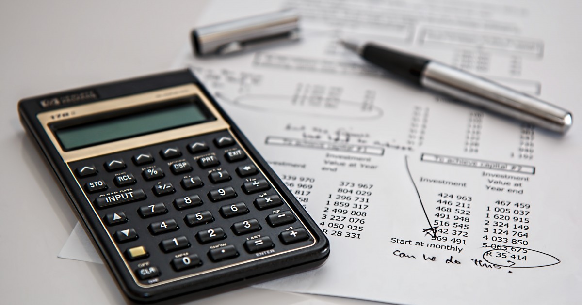 Tax documents and calculator on a desk